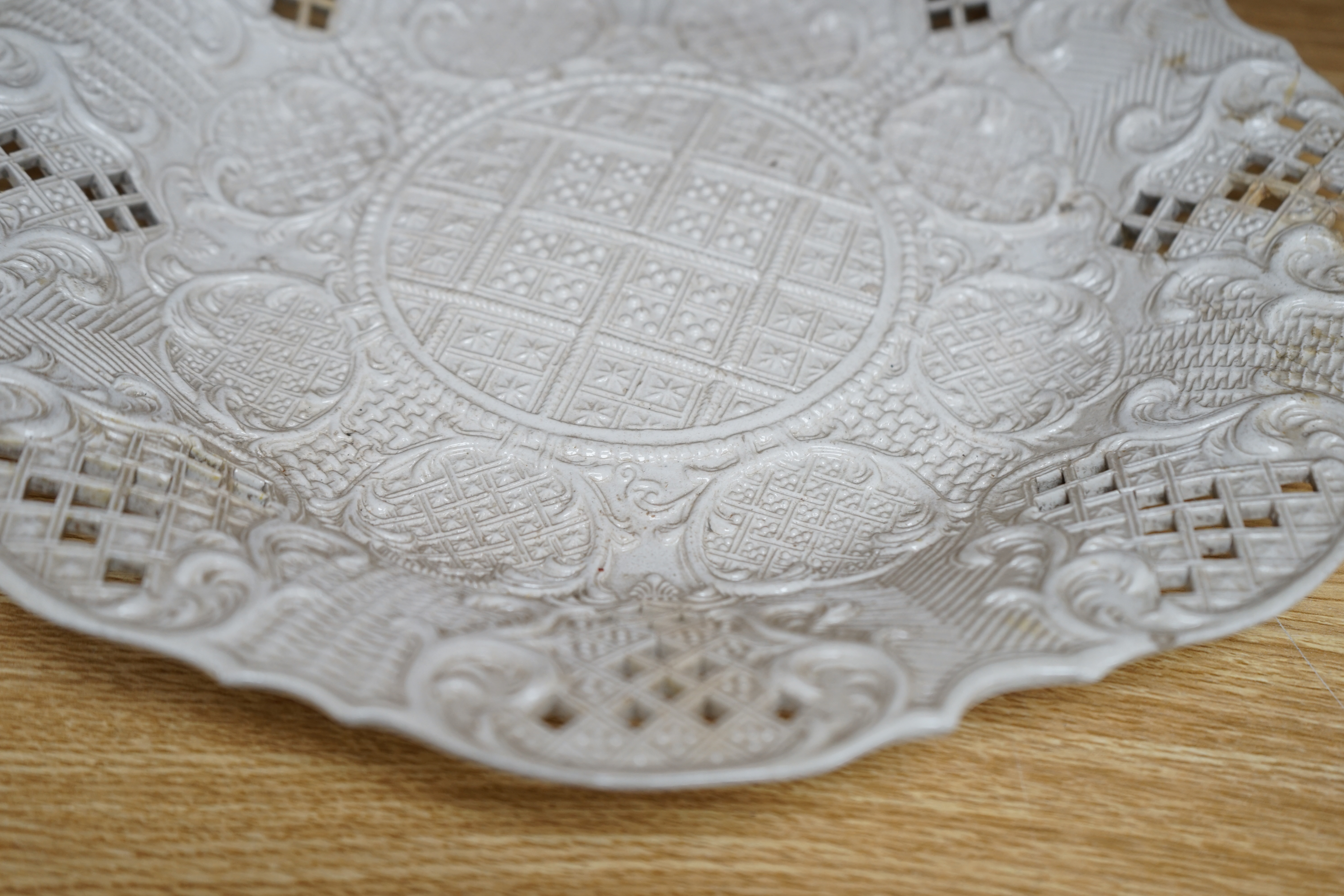 An 18th century white salt-glaze dish, diameter 31cm. (a.f.). Condition - poor, significant cracks and repair